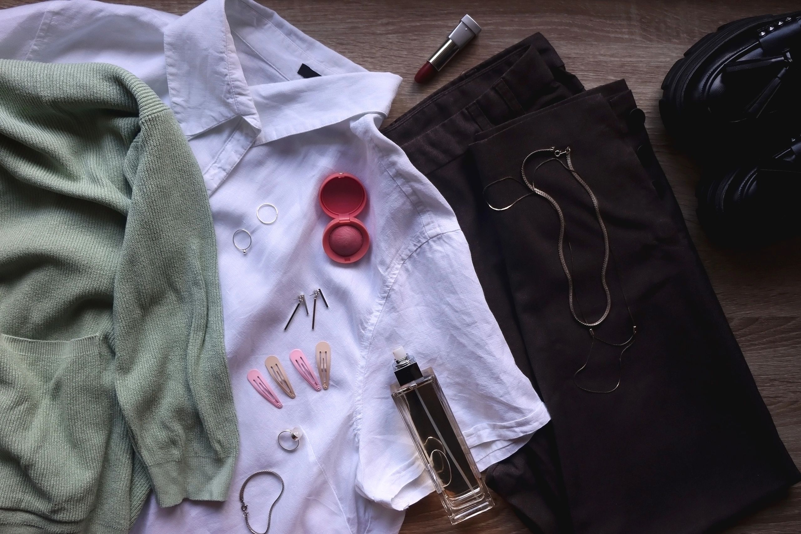 Pastel green cardigan, white shirt, gray trousers, black